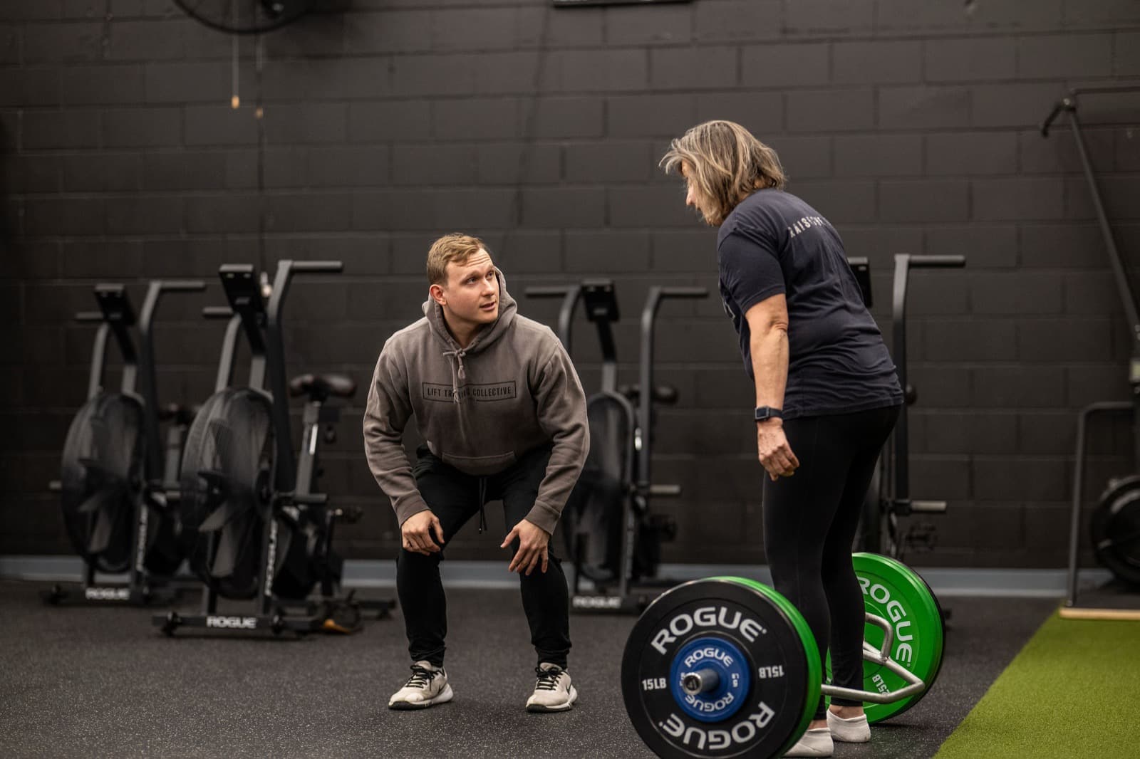 A LIFT coach watching a member's lunge form